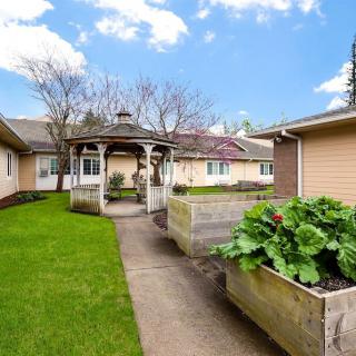 A charming house with a well-maintained garden and gazebo.