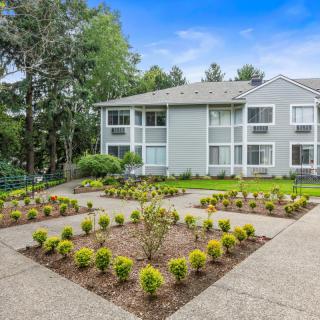 A well-maintained apartment building with landscaped gardens and pathways.