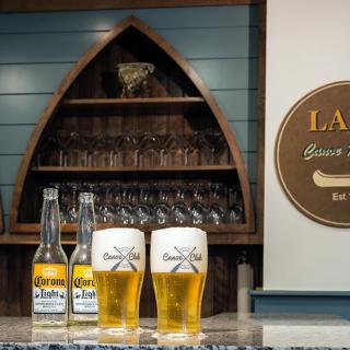 A cozy bar setting with bottles and glasses of beer displayed on the counter.