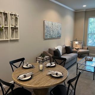 A cozy, modern living and dining area with neutral tones and stylish furnishings.