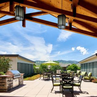 A scenic outdoor patio with seating area and mountain views.