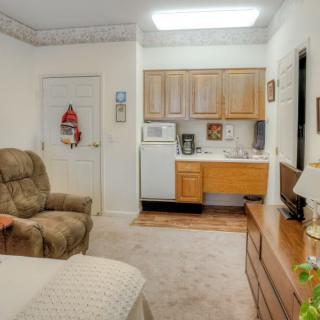 A cozy living space featuring a kitchenette and comfortable seating.