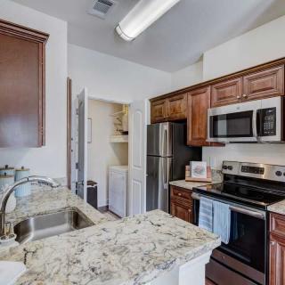 A modern kitchen with stainless steel appliances and granite countertops.