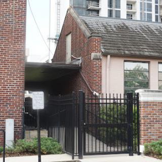 A view of a brick building with a gated entrance.