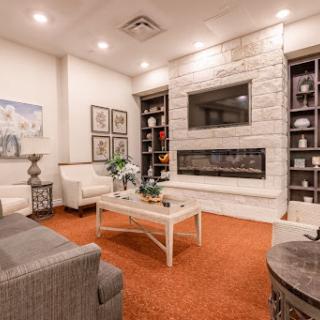 A modern living room featuring a stylish fireplace and comfortable seating.
