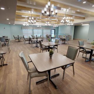 A modern dining area featuring well-spaced tables and contemporary lighting.