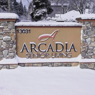 Arcadia Senior Living entrance sign covered in snow.