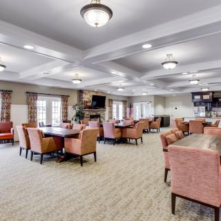 Spacious community lounge with multiple seating areas and modern lighting.