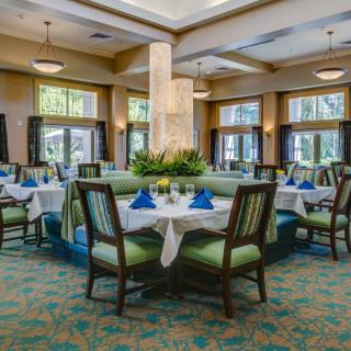 A beautifully set dining area with elegantly arranged tables and comfortable seating.