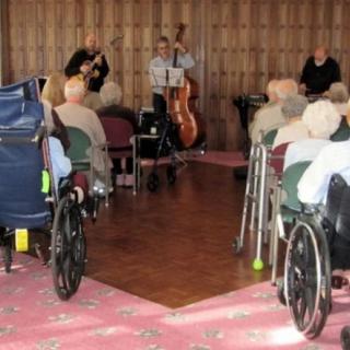 A musical performance for an elderly audience in a community setting.