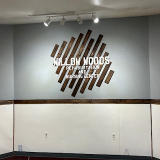 A stylish wall display featuring a wooden design with the name 'Willow Woods' prominently showcased.