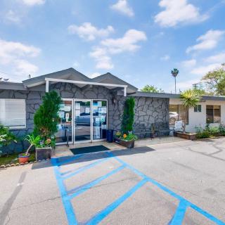 A small commercial building with a glass entrance and adjacent parking area, including handicap-accessible spaces.