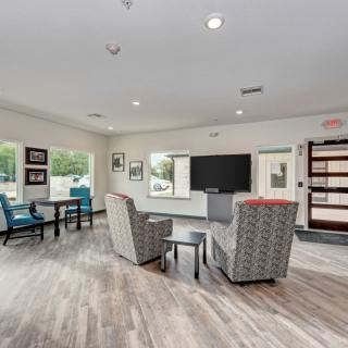 A modern living room with comfortable seating and a large TV.