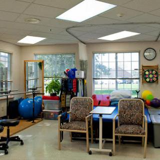 A bright and organized physical therapy room, equipped with various exercise tools to support rehabilitation.