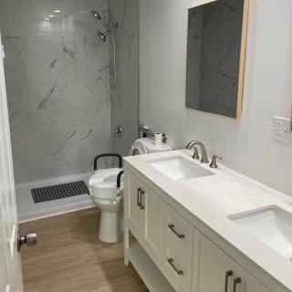 Modern bathroom with a double sink vanity and walk-in shower.
