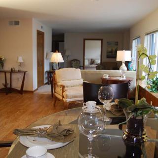 A cozy living and dining area with elegant furniture and warm lighting.