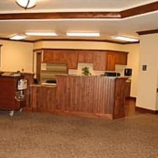 A reception area with wooden cabinets and a carpeted floor.