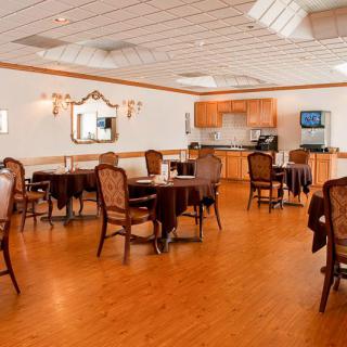A cozy dining area with wooden floors and comfortable seating arrangements.