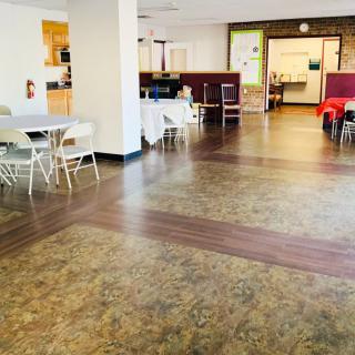 A spacious community center with seating areas and tables.