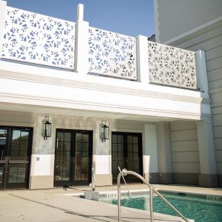 Modern architecture with intricate facade design and an outdoor swimming pool.