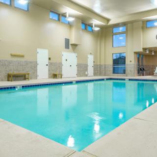 An indoor swimming pool with a bright and clean facility.
