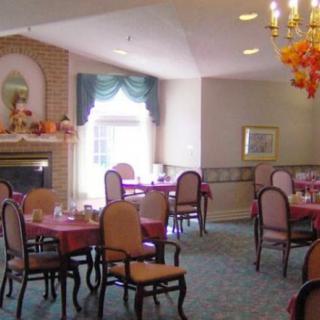 A cozy dining room with elegantly set tables and a warm atmosphere.