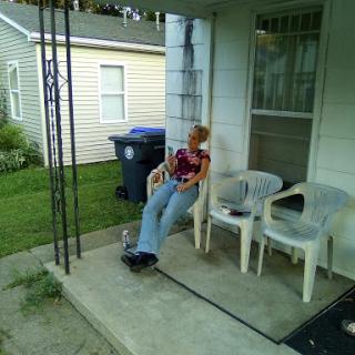 A person enjoying a moment of relaxation on the porch.