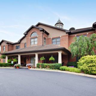 A large brick building with a welcoming entrance and well-maintained landscaping.