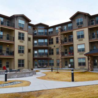 A multi-story apartment building with a courtyard area.