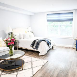 A bright and modern bedroom with minimalist decor and cozy furnishings.