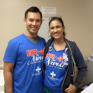 Two enthusiastic nurses posing together in their ER uniforms.