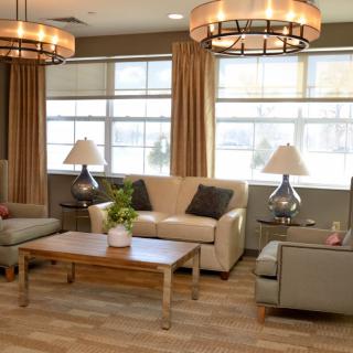 A cozy living room with comfortable seating and elegant lighting.