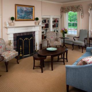 A traditional living room with elegant furniture and a fireplace.
