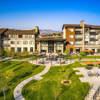 A modern residential complex with well-maintained green spaces and outdoor paths.