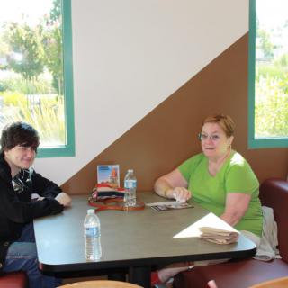 Two people sitting at a table in a restaurant.
