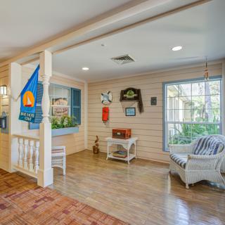 A cozy, decorated waiting area with seating and wooden flooring.