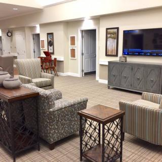 A modern living room with comfortable seating and a large television.