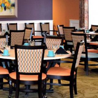 A well-arranged dining area with neatly set tables and chairs.