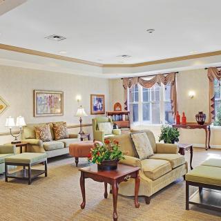 A cozy and elegantly decorated living room with comfortable seating and natural light.