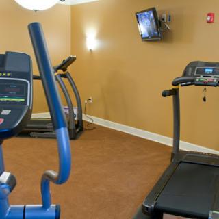 A small gym area featuring a treadmill and an elliptical machine, ideal for indoor workouts.
