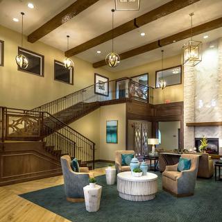 A modern and elegant lobby with a staircase, comfortable seating area, and stylish lighting.