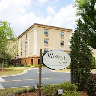 A view of the hotel exterior with a welcoming sign.