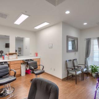 A well-lit hair salon with styling chairs and a cozy waiting area.