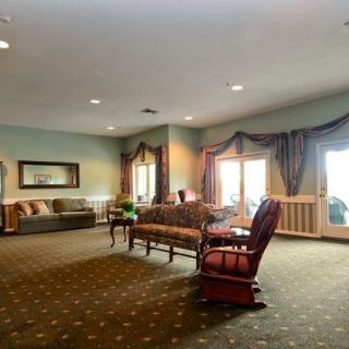 A spacious and elegantly decorated living room with comfortable seating and large windows.