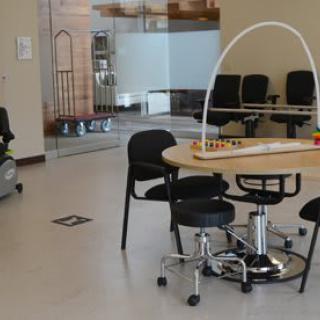 A modern waiting area with a round table and chairs.