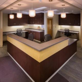 A modern reception area with a spacious desk and contemporary lighting.
