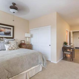 A cozy bedroom with neutral decor and elegant furnishings.