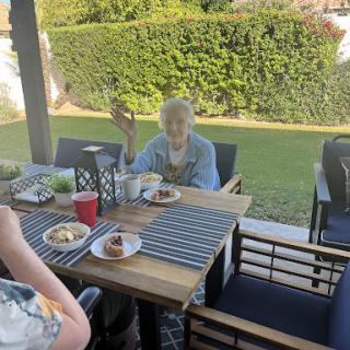Enjoying a meal together in the sunshine.