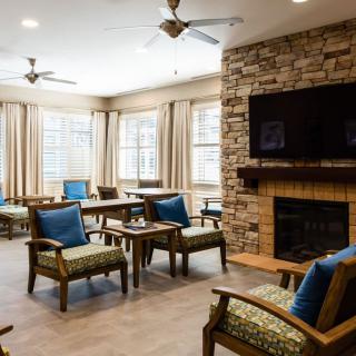 A cozy living room with comfortable seating, a fireplace, and a television.
