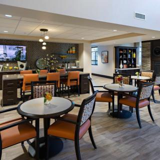 A modern lounge area with comfortable seating and a bar.
